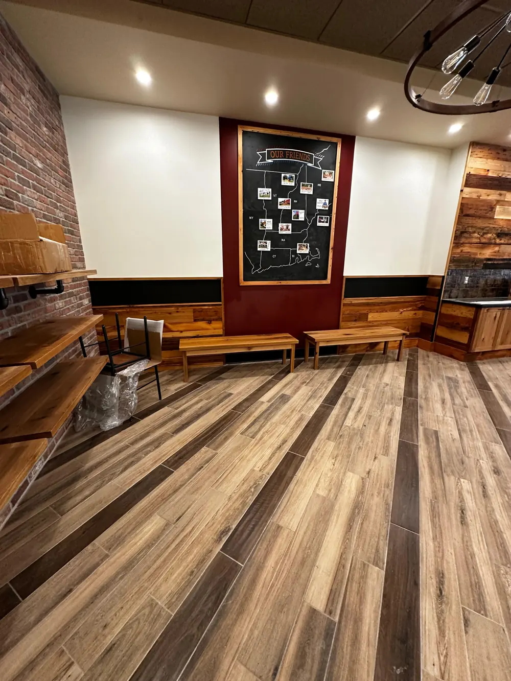Restaurant seating area with white walls and red accent wall